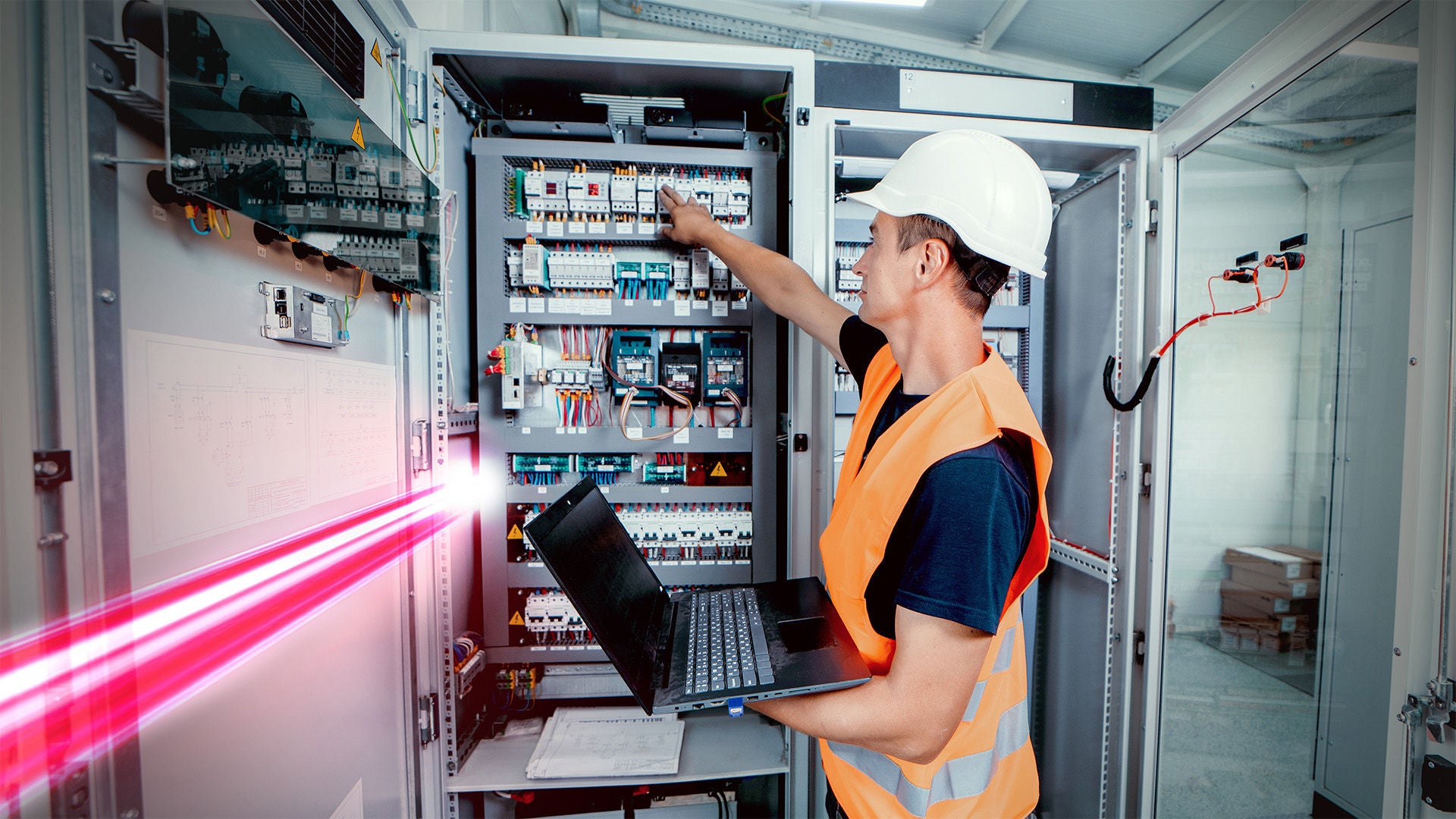 Technician in front of the control cabinet